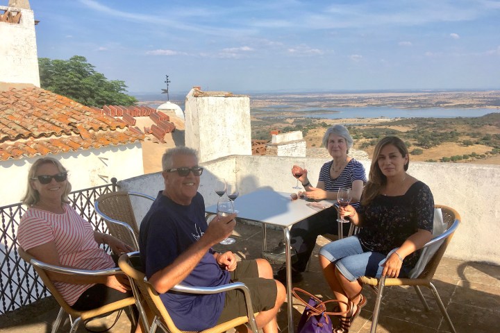 a group of people standing in front of a mountain