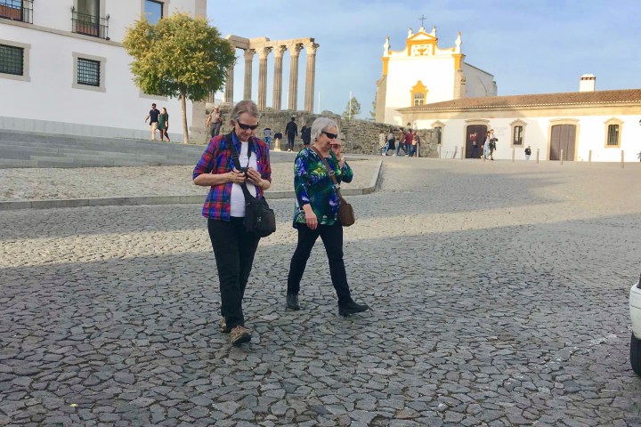 a group of people walking in front of a building