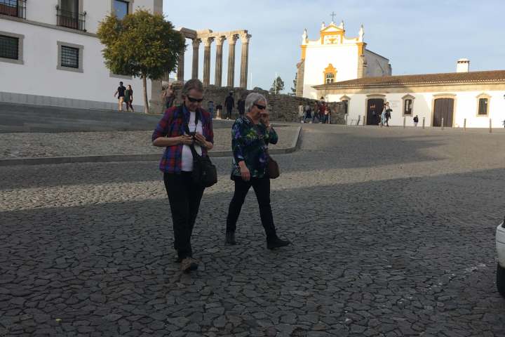 a group of people walking in front of a building
