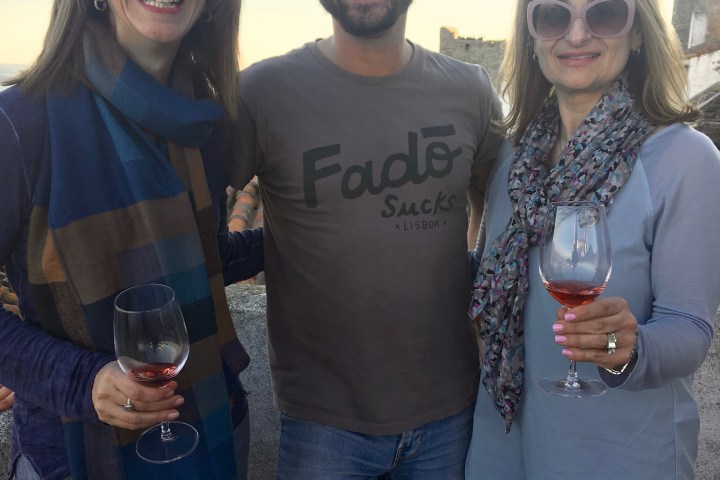 a group of people holding wine glasses
