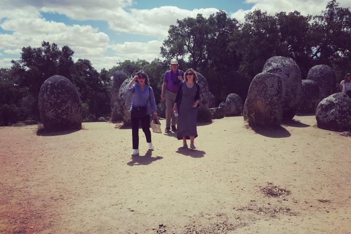 a group of people walking down a dirt road
